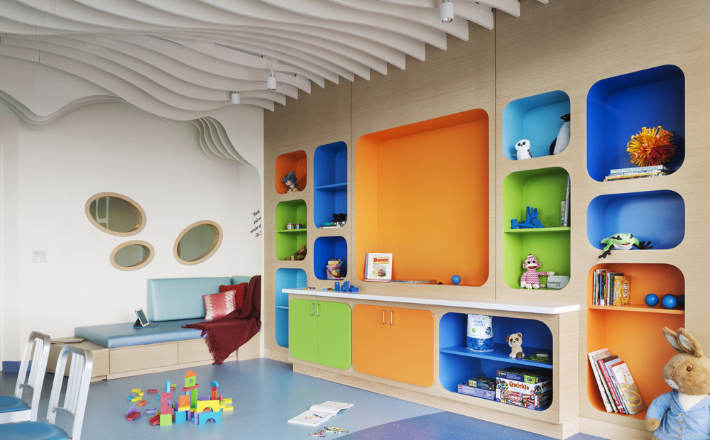 Children's play area with colorful bookshelves and toys 