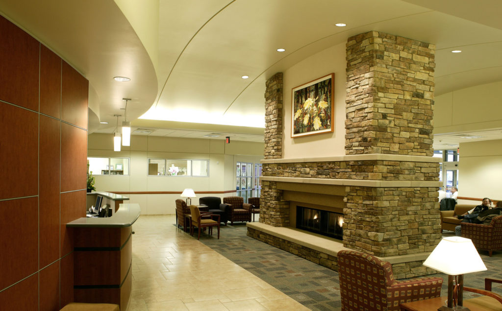 Hospital check in and waiting area with large fireplace