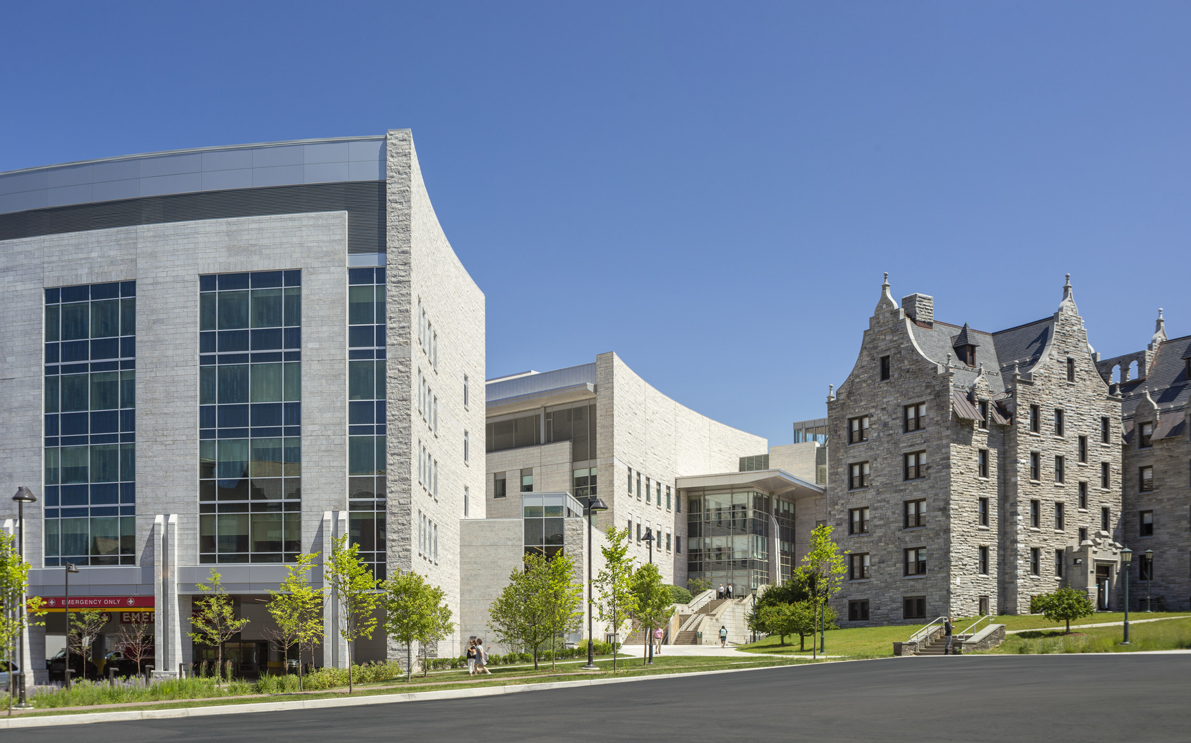 University of Vermont Medical Center campus buildings in the daytime, surrounded by plants, trees and staircases